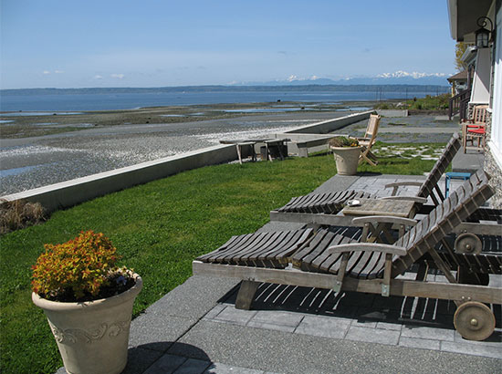 Lounge outside in the sun—just a few steps from the master suite and dining room. Seals, sea otters, and eagles are seen on a daily basis.