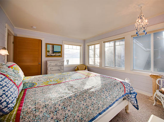Enjoy ocean views and excellent natural light in this queen bedroom.