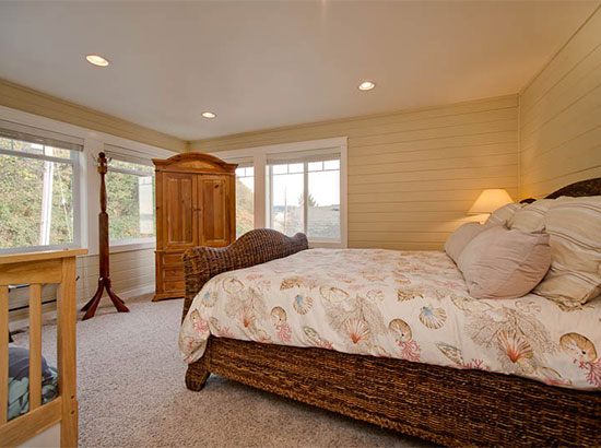 In this extra-large bedroom perfect for families, there is a twin/full bunk bed opposite the king bed and the pine armoire.